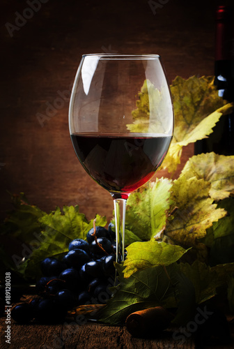 Fotografi Red wine from grapes of cabernet sauvignon variety, still life in rustic style w