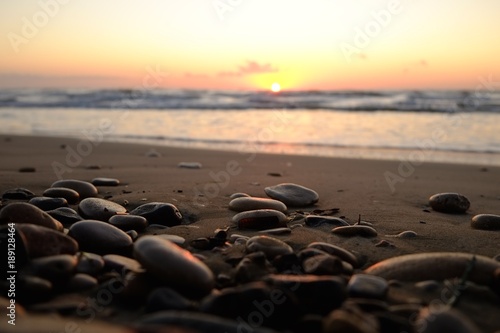 Small stones lying on the sandy beach