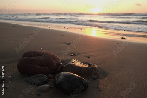 Small stones lying on the sandy beach