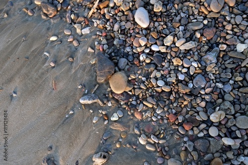 Small stones lying on the sandy beach