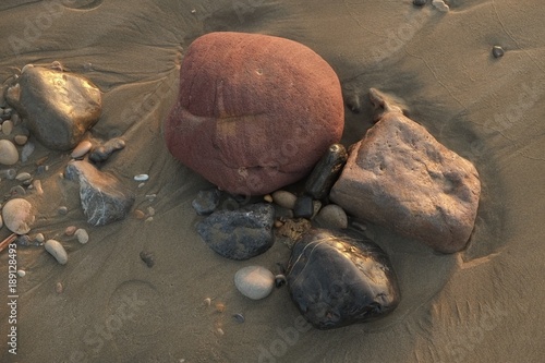 Stones lying on the sandy beach