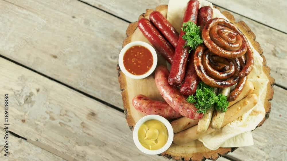 Grilled sausages top view. Tasty food on wooden board. Grilled sausages top view. Tasty food on wooden board.