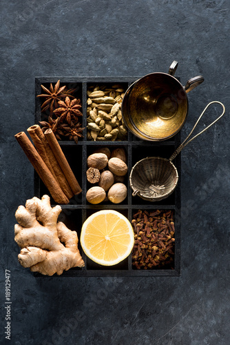 Spicy spices, lemon and ginger in a wooden box