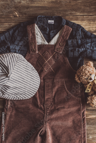 Flat lay photography of boy's casual outfits, Outfits of traveler, boy, male, Men's casual outfits on wood board background - Vintage effect style picture photo