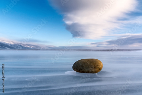 Stone on the ice of Lake Baikal