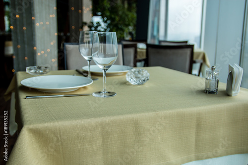 Restaurant empty table for two with window view.