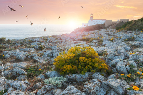 Lighthouse at colorful sunset