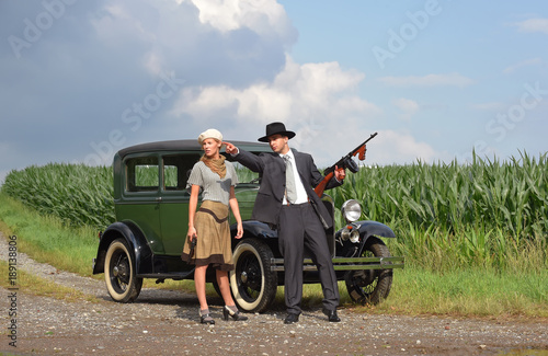 Two models get dressed up in 1930's style vintage fashion clothes and act the role of the gangster duo Bonnie and Clyde.