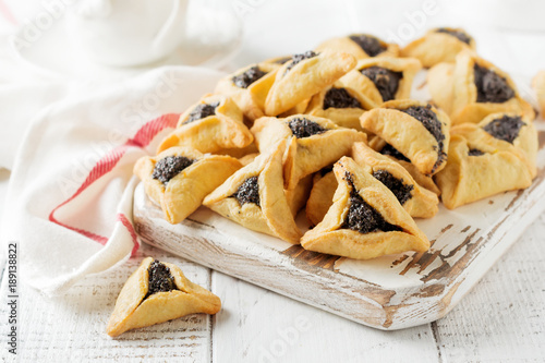 Traditional Jewish Hamantaschen cookies with berry jam. Purim celebration concept. Jewish carnival holiday background. Selective focus. Copy space.