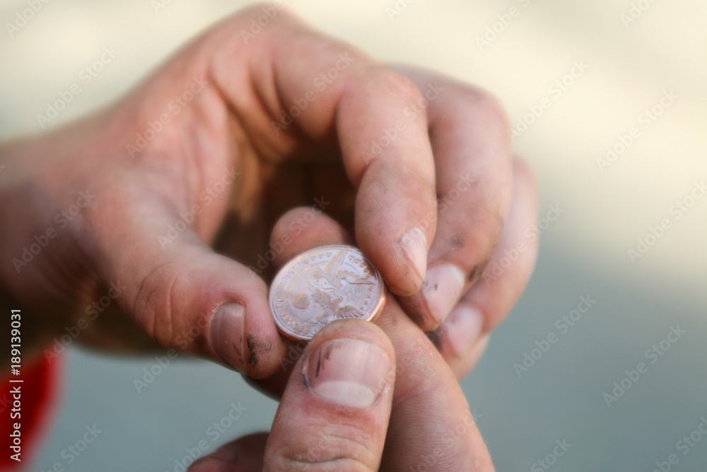 wedding coin for good luck in the hands of male workers wedding coin for good luck in the hands of male workers