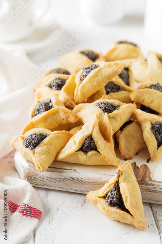 Traditional Jewish Hamantaschen cookies with berry jam. Purim celebration concept. Jewish carnival holiday background. Selective focus. Copy space. photo