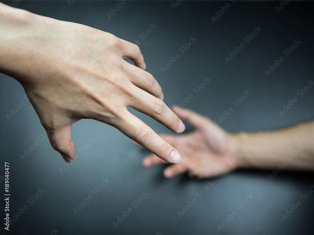 Hands reaching to each other on background