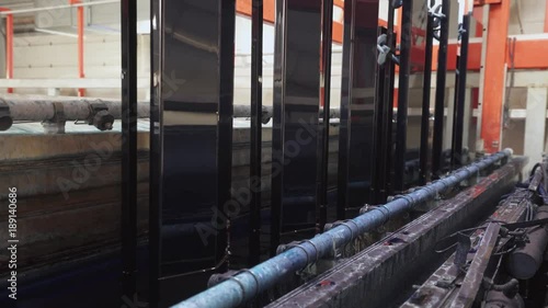 Wallpaper Mural Manufacture. Process of anodizing aluminum plates in production, Immersion of aluminum plates in liquid. Automatic production line.
 Torontodigital.ca