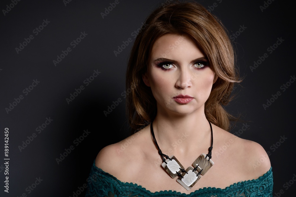Studio beauty shot of woman with flint stone necklace.