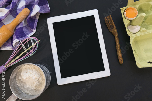 White tablet with copy space with Ingredients for cooking Italian pasta on dark stone surface, top view