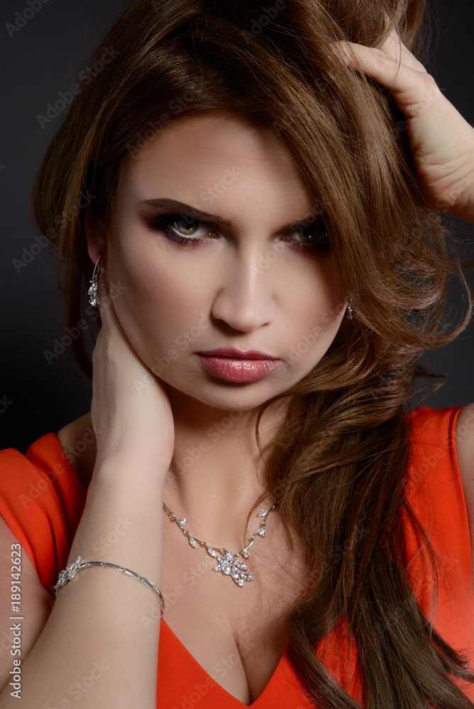 Studio beauty shot of woman with silver necklace and bracelet.