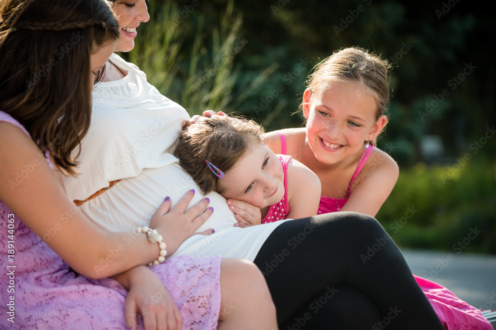 Happy pregnant mother with kids outdoor in summer nature Happy pregnant mother with kids outdoor in summer nature