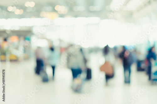 Blurred background,Traveler with baggage at Terminal Departure Check-in at airport with bokeh light,transportation concept.