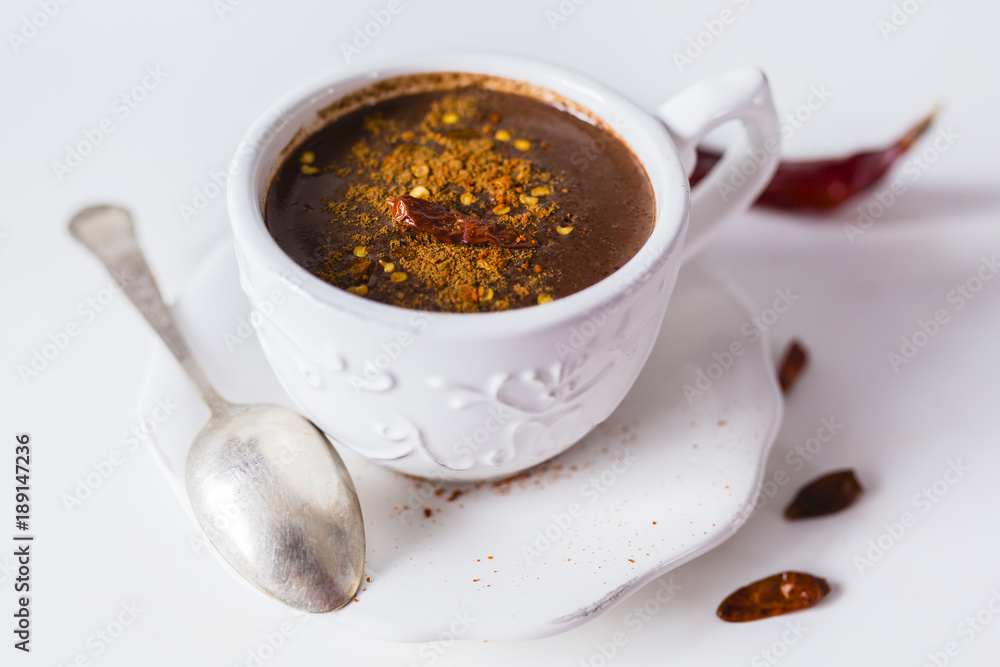 Delicious hot chocolate with chili on a white background. Delicious hot chocolate with chili on a white background.