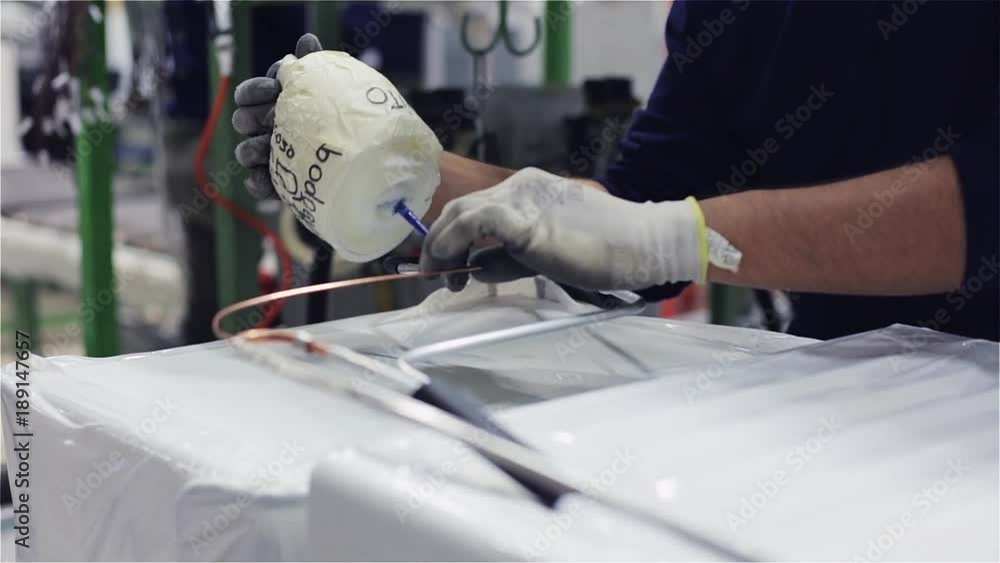Worker in Production line in the Fridge Factory Worker in Production line in the Fridge Factory