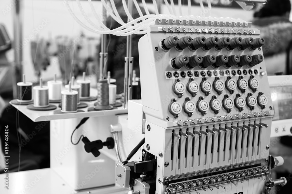 Naklejka premium Industrial sewing machine close-up, monochrome