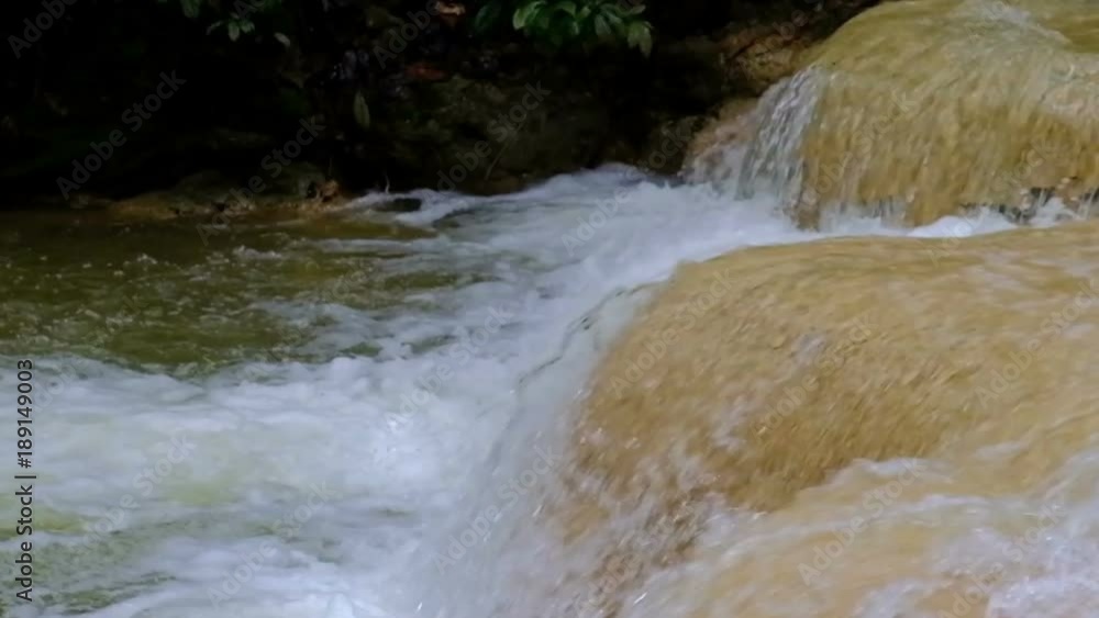 waterfall in rainforest. cascade in forest. water flowing in tropical jungle in spring waterfall in rainforest. cascade in forest. water flowing in tropical jungle in spring