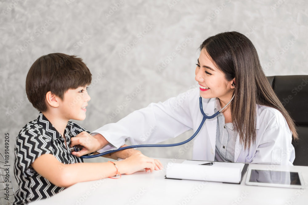 Asian woman doctor, check up heartbeat of kid, healthcare and medical for kid concept Asian woman doctor, check up heartbeat of kid, healthcare and medical for kid concept