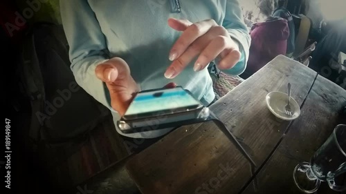 Girl in cafe connecting to internet to post vacation pictures in social media