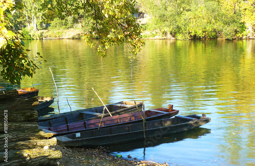 Pristine riverbank, three boats. Tisa river, Hungary in the Tokaj wine region
