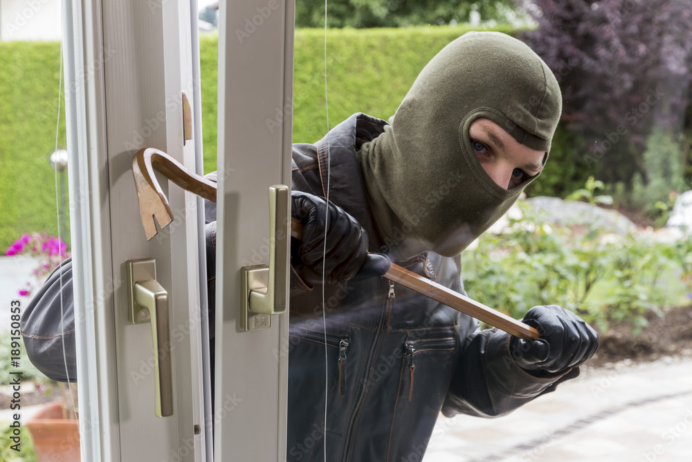 burglar at a window - obrazy, fototapety, plakaty 