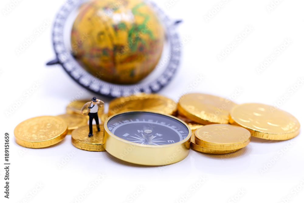 Miniature people : businessman and Tie blowing in wind stand on gold coins and compass, business and travel concept. Miniature people : businessman and Tie blowing in wind stand on gold coins and compass, business and travel concept.