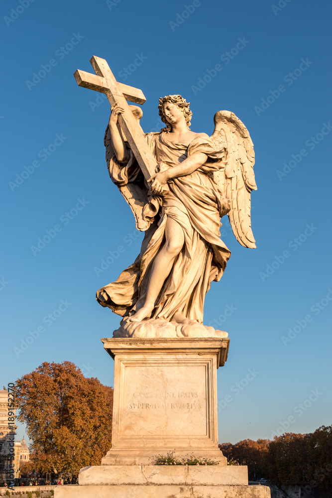  Marble statue of angel with cross. Sant Angelo Bridge in Rome. Italy.