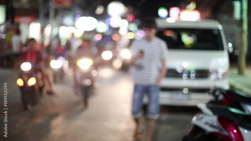 Handsome man walks on the street from blurred bokeh nackground smiles, uses his smartphone. Modern technology. 1920x1080 Handsome man walks on the street from blurred bokeh nackground smiles, uses his smartphone. Modern technology. 1920x1080