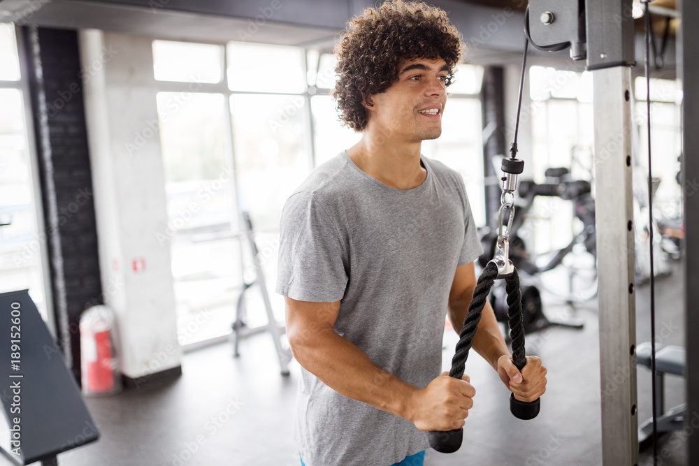 Young handsome man doing exercises in gym Young handsome man doing exercises in gym