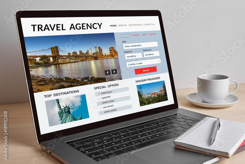 Travel agency concept on modern laptop computer screen on wooden table. All screen content is designed by me.  © maicasaa