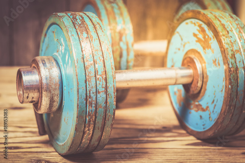 Fotografie Vintage dumbbells on the wooden floor