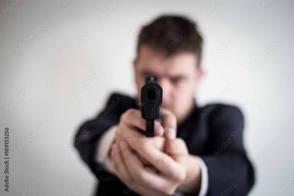 A thief in a suit with a gun directed at a man takes cash, hundreds of dollars are abducted with the help of a pistol, a crime, an armed robbery A thief in a suit with a gun directed at a man takes cash, hundreds of dollars are abducted with the help of a pistol, a crime, an armed robbery