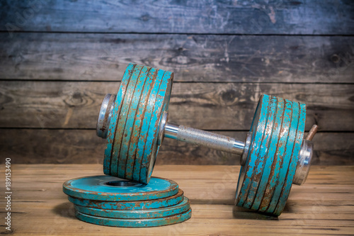 Vintage dumbbell on the wooden floor.