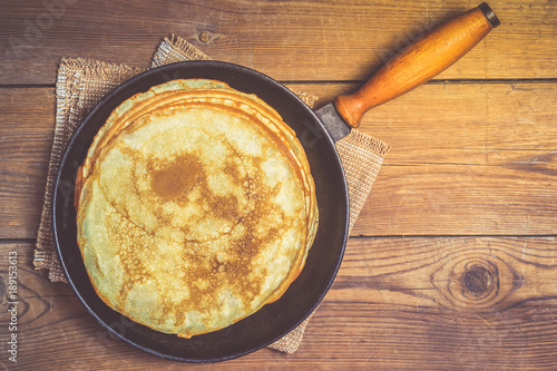 Stack of pancakes on a cast-iron frying pan