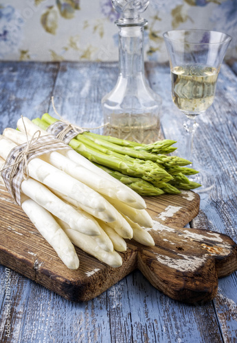 Row green and white Asparagus as close-up on a cutting board