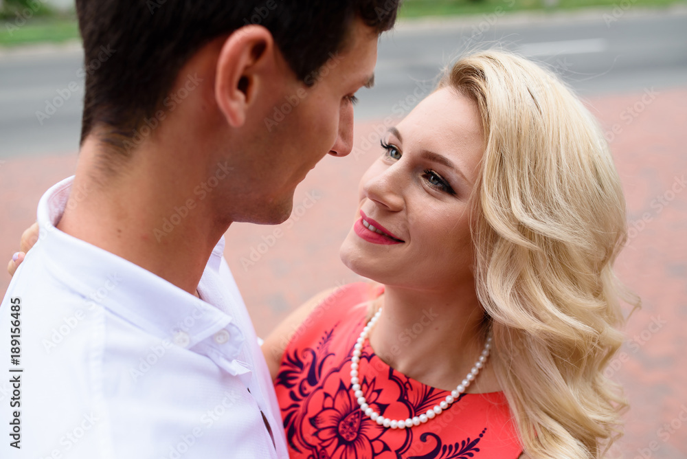 A loving couple hugs and walks in the park. A loving couple hugs and walks in the park.