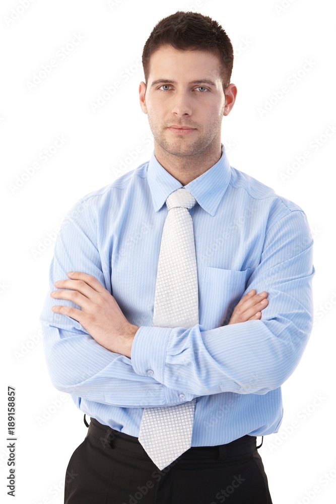 Confident businessman standing arms crossed