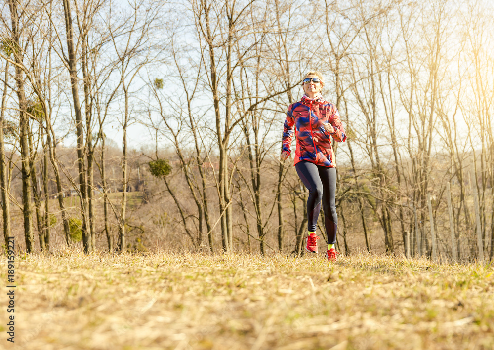 Running woman. Female Runner Jogging during Outdoor Workout in a Park.