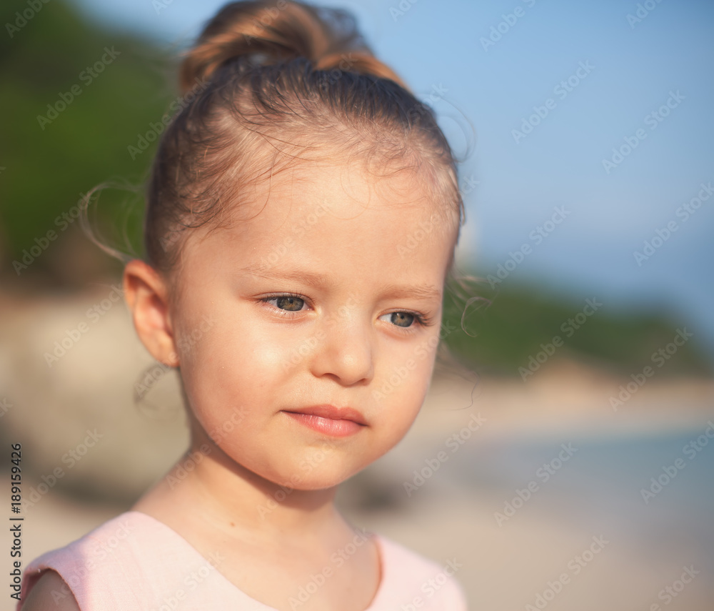 Beautiful little girl at the beach. Sunblock cream for children. Beautiful little girl at the beach. Sunblock cream for children.