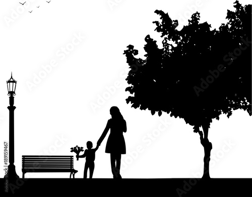 Mother walks with a son with flowers in the park, one in the series of similar images silhouette