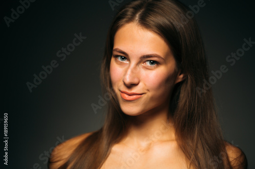 Portrait beautiful girl on a dark studio background