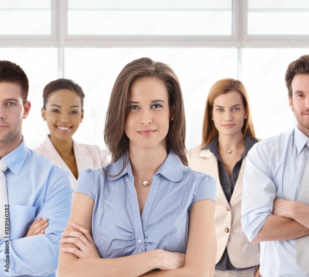 Smiling businesswoman and business team Smiling businesswoman and business team