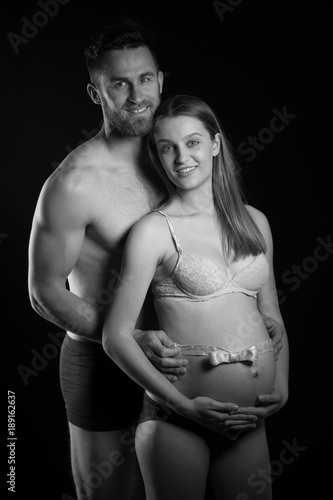 Pregnant woman and her man  studio black and white photography