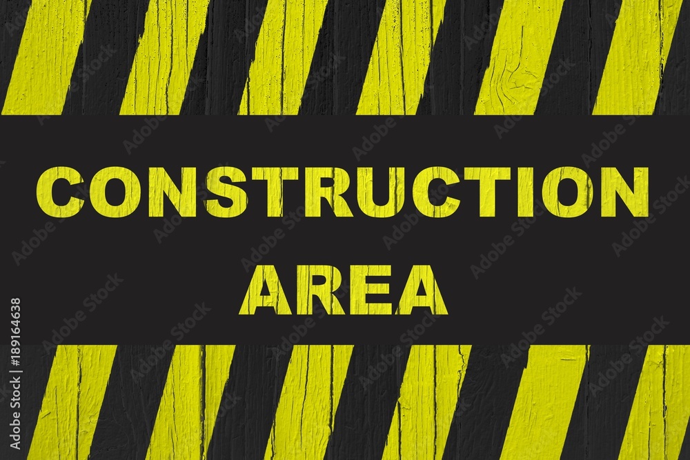 Construction area warning sign with yellow and black stripes painted ...