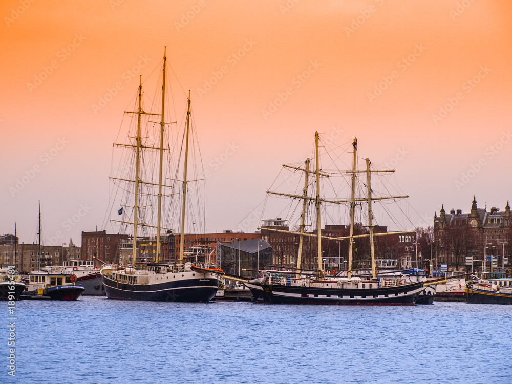 Old wooden ships in Amsterdam harbour, Netherlands.